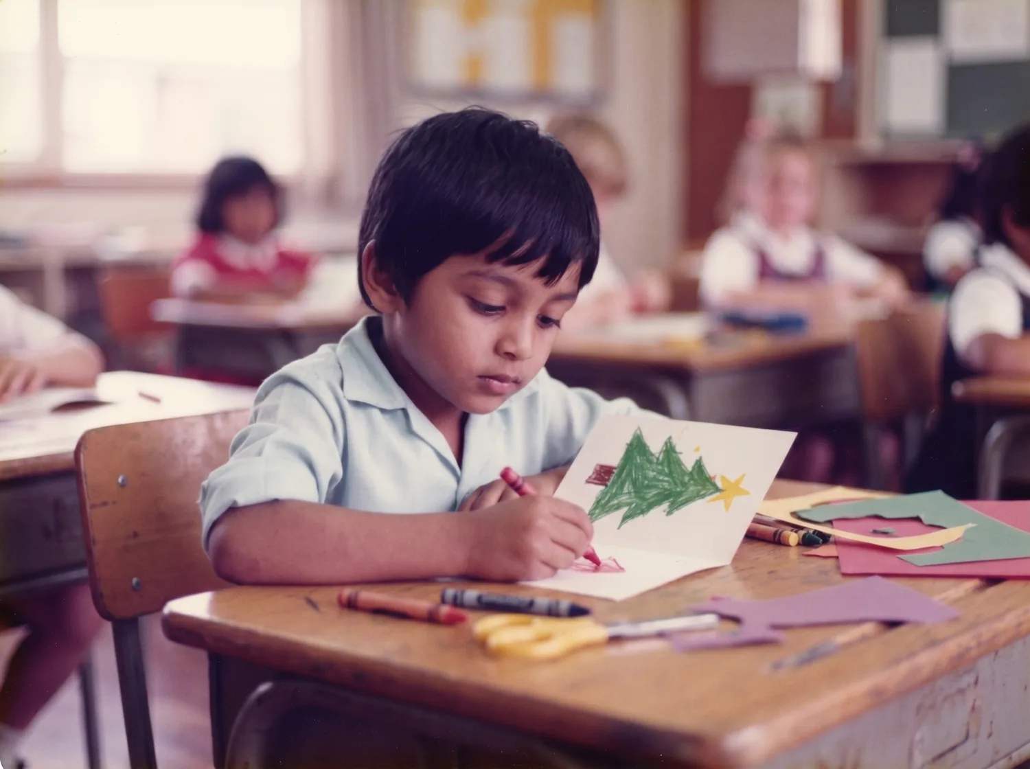 A young Rahim aged about five, colouring a homemade Christmas card at his primary-school desk with other children behind