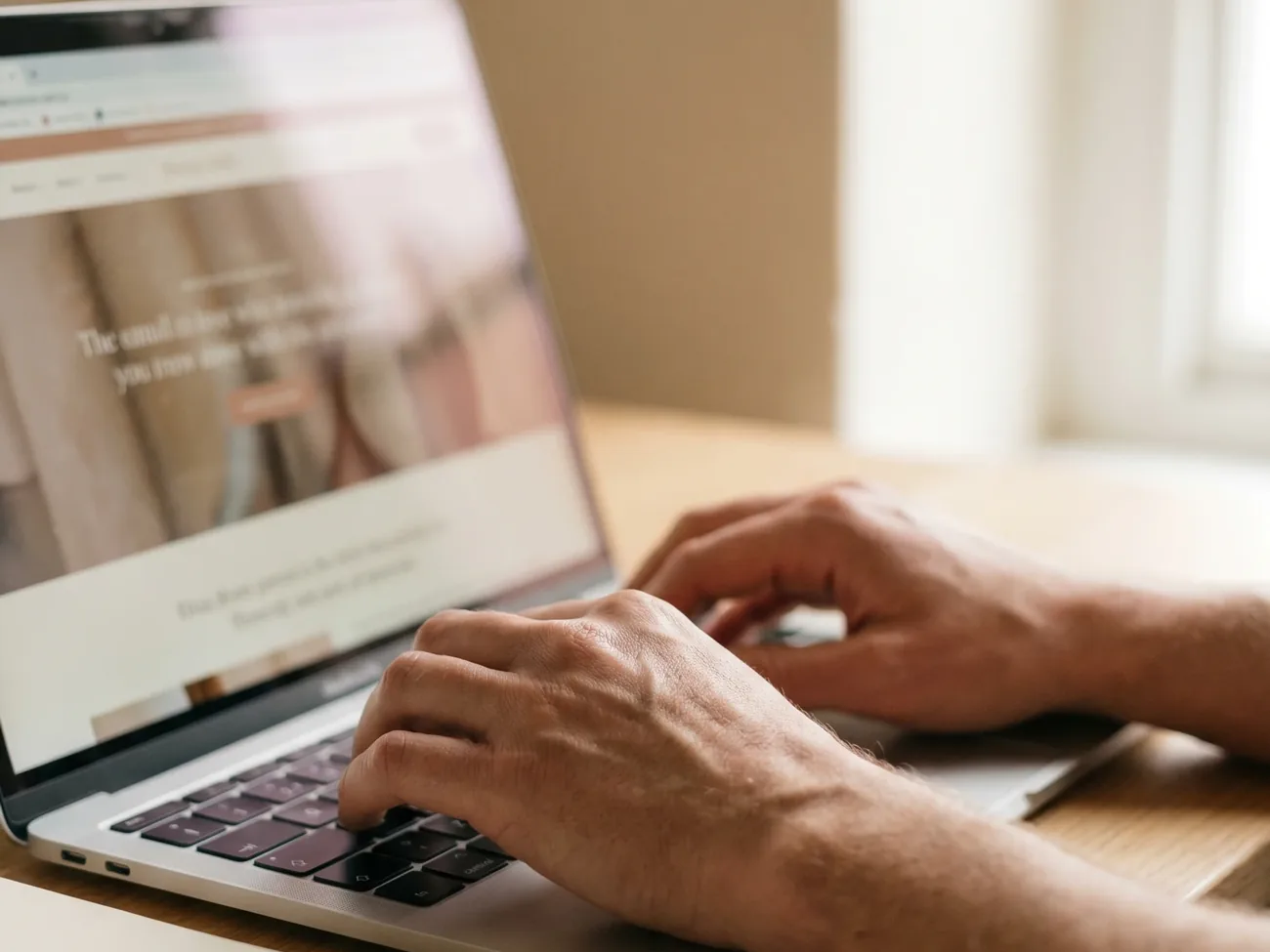 Close-up of a visitor browsing a Squarespace website on a laptop, looking for an easy way to get in touch