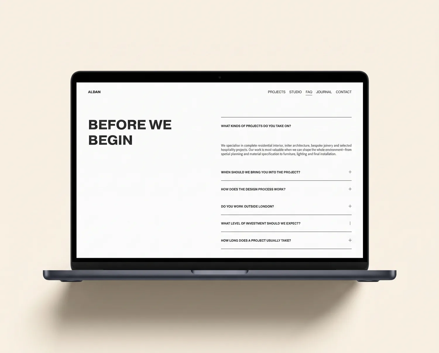 Basalt Squarespace interior design FAQ page with accordion, shown on a laptop
