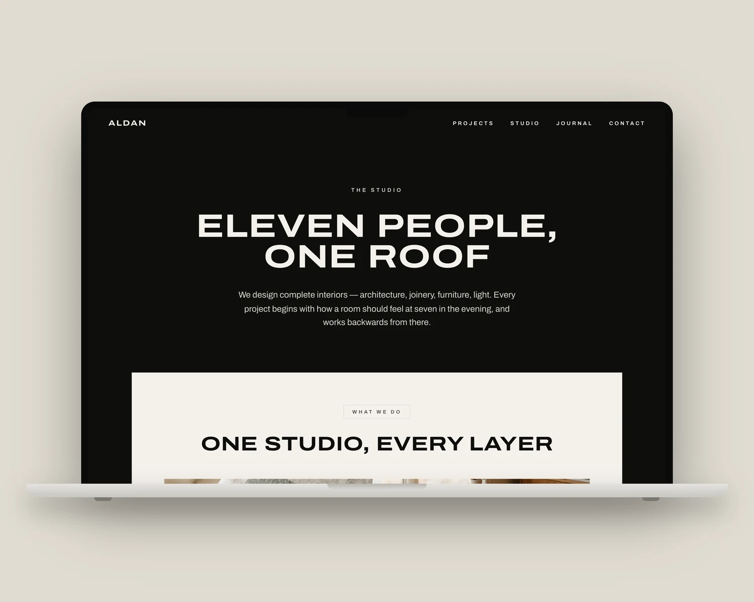 The Basalt template homepage on a laptop, showing a full-bleed interior photograph with a large editorial headline