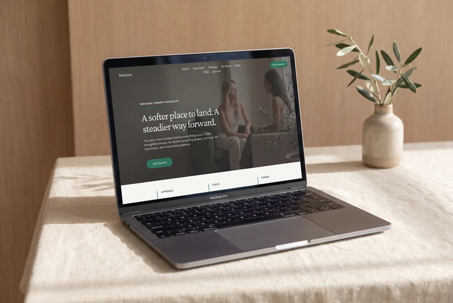 The Morrow template homepage on a laptop — a calm therapy-session photograph with the headline ‘A softer place to land. A steadier way forward.’