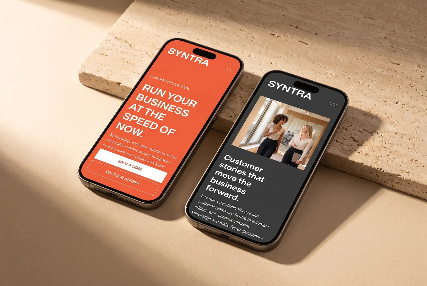 Two iPhones on warm stone showing the Syntra template&rsquo;s mobile homepage and customer stories page