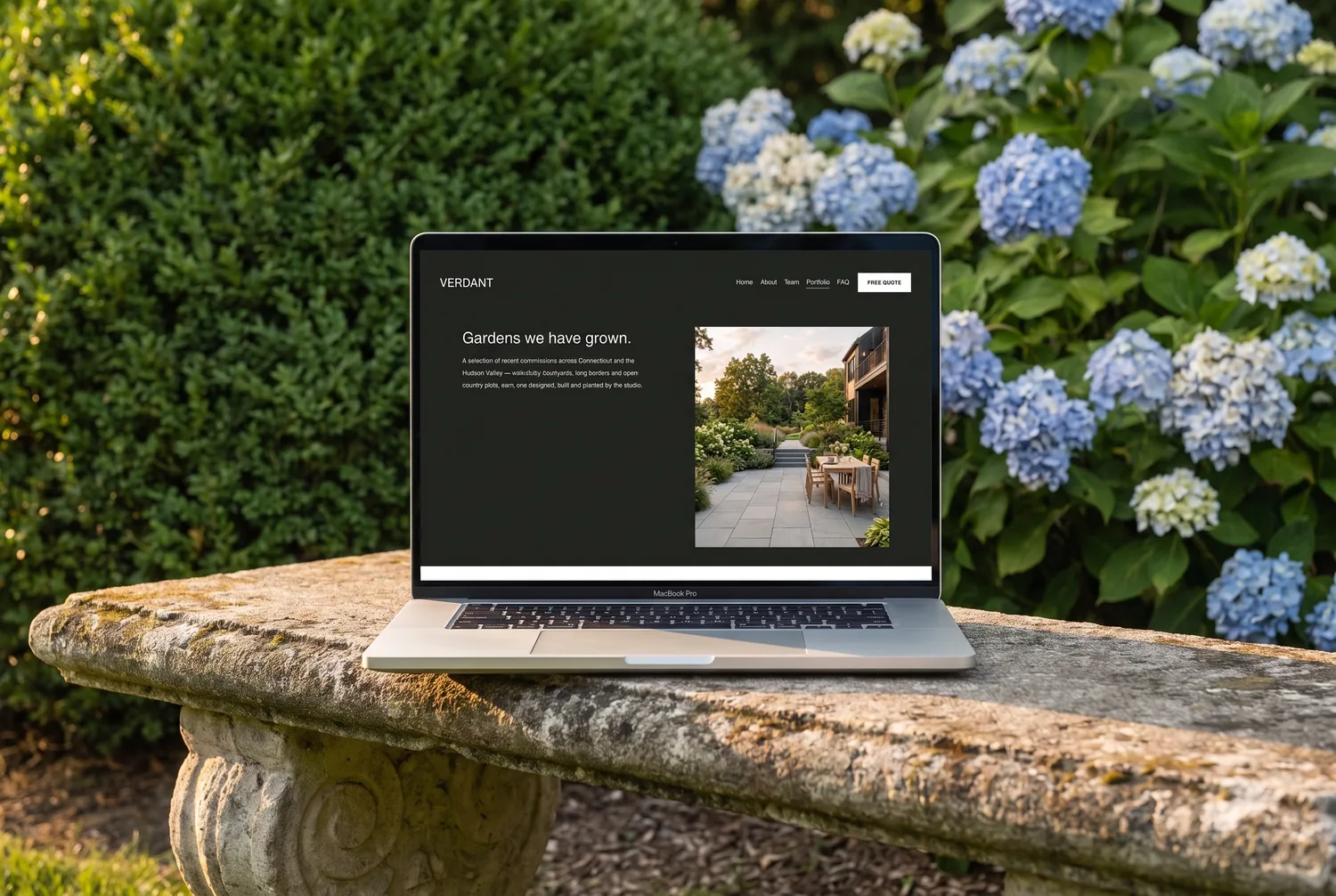 Verdant template portfolio page on a laptop in a garden — &lsquo;Gardens we have grown&rsquo; with a project gallery