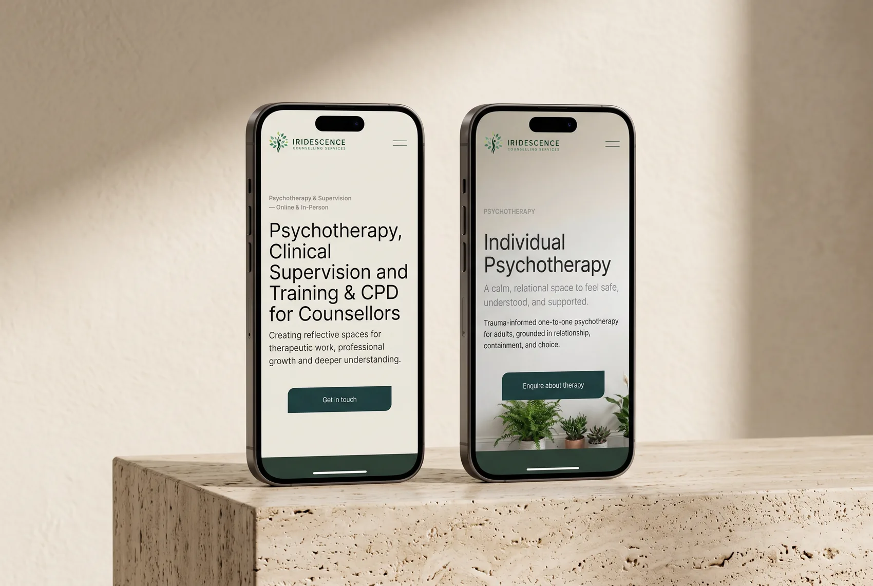 The Iridescence homepage and Individual Psychotherapy page on two iPhones standing on a travertine plinth